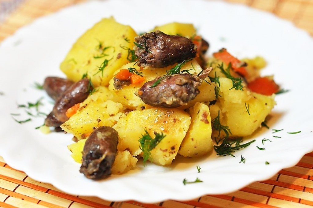 Добавление овощей в куриные сердца с картошкой